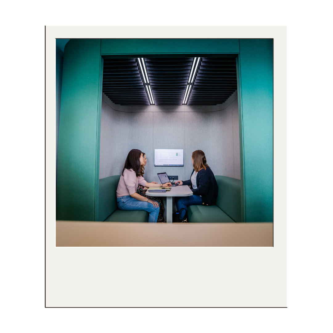 3 people meeting in the West Hub Pod, sharing screen on the monitor.